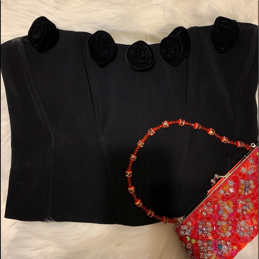Black bustier/ fitted with bra wire.
